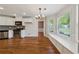 Breakfast nook with a wall of windows and built-in bench seating adjacent to kitchen at 705 Trickum Valley Dr, Woodstock, GA 30188