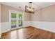 Bright dining room featuring hardwood floors, modern lighting, and French doors that lead to the deck at 705 Trickum Valley Dr, Woodstock, GA 30188