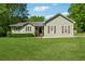 Charming single-story home featuring a well-manicured lawn, decorative shutters, and mature trees offering curb appeal at 705 Trickum Valley Dr, Woodstock, GA 30188