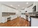 Spacious kitchen with white cabinets, granite countertops, stainless steel appliances, and hardwood floors at 705 Trickum Valley Dr, Woodstock, GA 30188