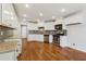 Modern kitchen featuring white cabinets, granite countertops, stainless steel appliances, and hardwood floors at 705 Trickum Valley Dr, Woodstock, GA 30188