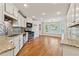 Bright kitchen featuring white cabinets, stainless steel appliances, granite counters, and a sunlit breakfast nook at 705 Trickum Valley Dr, Woodstock, GA 30188