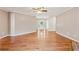 Open-concept living room boasts beautiful hardwood floors and neutral paint, with ample space for relaxation at 705 Trickum Valley Dr, Woodstock, GA 30188