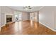 Spacious living room featuring a brick fireplace, ceiling fan and hardwood floors with ample natural light at 705 Trickum Valley Dr, Woodstock, GA 30188