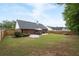Spacious backyard featuring a patio with outdoor seating, a lush lawn, and privacy fence at 1031 Ludwick Way, Lawrenceville, GA 30046