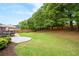 Spacious backyard with a well-maintained lawn, privacy fence, and an outdoor dining set at 1031 Ludwick Way, Lawrenceville, GA 30046