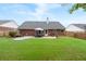 Large backyard featuring a patio with dining set, perfect for outdoor entertaining at 1031 Ludwick Way, Lawrenceville, GA 30046
