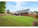 Expansive backyard features a lush lawn, mature trees, and fenced perimeter, ideal for recreation at 1031 Ludwick Way, Lawrenceville, GA 30046