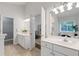 Bright bathroom boasts dual sinks, white cabinets, and an open doorway to the bedroom at 1031 Ludwick Way, Lawrenceville, GA 30046