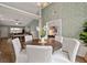 Open-concept dining room with elegant wallpaper, wood floors, and views into the living area at 1031 Ludwick Way, Lawrenceville, GA 30046