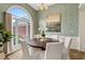 Bright dining room with a large arched window, chandelier, and seating for six people at 1031 Ludwick Way, Lawrenceville, GA 30046