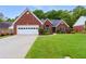 Charming single-Gathering home with a well-manicured lawn and a two-car garage, complemented by vibrant landscaping at 1031 Ludwick Way, Lawrenceville, GA 30046