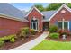 Charming brick home featuring a front entrance with a manicured flower bed at 1031 Ludwick Way, Lawrenceville, GA 30046