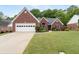 Charming brick home with a well-maintained lawn, two-car garage, and beautiful landscaping at 1031 Ludwick Way, Lawrenceville, GA 30046