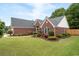 Charming front yard features a well-manicured lawn and mature landscaping, enhancing the home's curb appeal at 1031 Ludwick Way, Lawrenceville, GA 30046