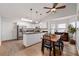Modern kitchen with white cabinets, stainless steel appliances, and a dining area with a table at 1031 Ludwick Way, Lawrenceville, GA 30046