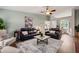 Open-concept living room with high ceilings, a ceiling fan, and views of the dining area at 1031 Ludwick Way, Lawrenceville, GA 30046