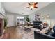 Cozy living room features a fireplace, wood floors, and comfortable seating with natural lighting at 1031 Ludwick Way, Lawrenceville, GA 30046
