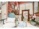 Bathroom with a tub, a framed mirror, unique wallpaper, and vintage-looking decor at 110 Emerald Dr, Mcdonough, GA 30253
