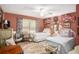 Bedroom with two beds, ceiling fan, area rug, window, and unique decor at 110 Emerald Dr, Mcdonough, GA 30253