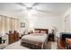 Bedroom with neutral walls and carpet, ceiling fan, and dark-wooden furniture at 110 Emerald Dr, Mcdonough, GA 30253