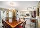 A dining room showcasing a large wooden table adjacent to the white kitchen at 110 Emerald Dr, Mcdonough, GA 30253