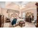 Main bedroom with tray ceiling, ceiling fan, wooden furniture, and area rug at 110 Emerald Dr, Mcdonough, GA 30253