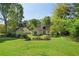 Spacious backyard with mature trees surrounding the perimeter of the property at 1220 Paddocks Way, Powder Springs, GA 30127