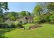 This backyard features mature trees, green grass, and a storage shed at 1220 Paddocks Way, Powder Springs, GA 30127