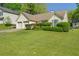 Ranch-style home featuring a two-car garage, manicured lawn, and mature shrubbery at 1220 Paddocks Way, Powder Springs, GA 30127