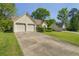 Ranch-style home featuring a two-car garage and a long driveway at 1220 Paddocks Way, Powder Springs, GA 30127
