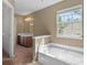 Tub and vanity in main bathroom at 1220 Paddocks Way, Powder Springs, GA 30127