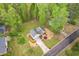 Aerial view showcasing home's location, driveway, and proximity to lush trees at 128 Partridge Rdg, Woodstock, GA 30188