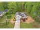 Aerial view of home with a long driveway, two-car garage, and beautiful landscaping at 128 Partridge Rdg, Woodstock, GA 30188