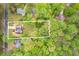 An aerial view shows the home nestled on a large, private lot surrounded by mature trees at 128 Partridge Rdg, Woodstock, GA 30188