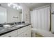 This full bathroom includes a granite vanity top, white cabinets and shower/tub combo at 128 Partridge Rdg, Woodstock, GA 30188