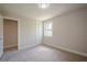 This bedroom features neutral walls, plush carpet, closet, and natural light at 128 Partridge Rdg, Woodstock, GA 30188