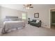 This cozy bedroom features neutral walls, plush carpet, ceiling fan, and lots of natural light at 128 Partridge Rdg, Woodstock, GA 30188
