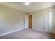 This bedroom has a closet, neutral walls, plush carpet, and is move-in ready at 128 Partridge Rdg, Woodstock, GA 30188