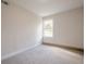 This bedroom features neutral carpeting, light walls and a bright window at 128 Partridge Rdg, Woodstock, GA 30188