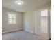 This bedroom has a closet, a window, neutral walls, and plush carpet at 128 Partridge Rdg, Woodstock, GA 30188