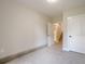 This bedroom has neutral carpet, light paint, and a door leading to the staircase at 128 Partridge Rdg, Woodstock, GA 30188