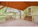 The deck features wooden stairs and railings, offering a view of the yard and surrounding trees at 128 Partridge Rdg, Woodstock, GA 30188