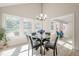 Bright dining room features large windows, modern chandelier and seating for four at 128 Partridge Rdg, Woodstock, GA 30188