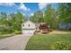 Charming front exterior with a two-car garage, lovely landscaping, and a well-manicured lawn at 128 Partridge Rdg, Woodstock, GA 30188