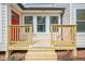 A welcoming front porch with fresh flowers and a bright red door invites you into this beautiful home at 128 Partridge Rdg, Woodstock, GA 30188