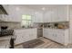 Beautiful kitchen features white cabinets, marble countertops, and stainless steel appliances at 128 Partridge Rdg, Woodstock, GA 30188