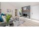 Inviting living room with a stone fireplace, light wood floors, and neutral paint at 128 Partridge Rdg, Woodstock, GA 30188
