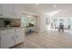 Bright living room and kitchen features large windows and open floorplan at 128 Partridge Rdg, Woodstock, GA 30188