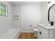 Modern bathroom with subway tile, tub, and white vanity at 1917 Connally Dr, Atlanta, GA 30344
